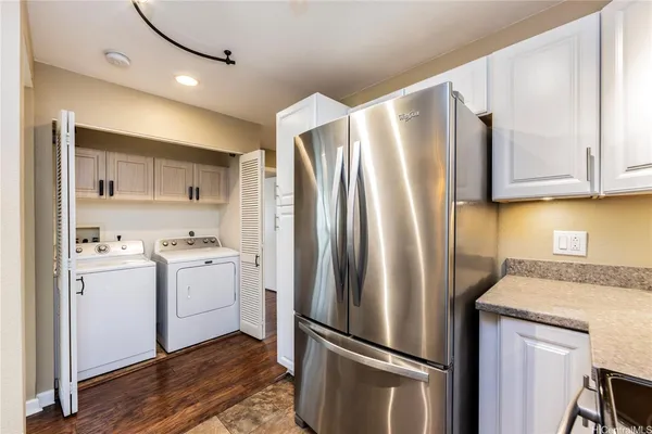 a kitchen with a refrigerator sink and cabinets
