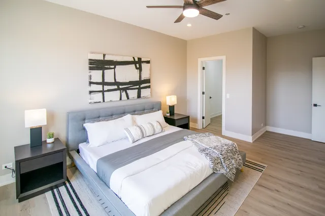 a spacious bedroom with a bed and a window