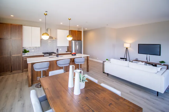 a room with a table chairs and a living room