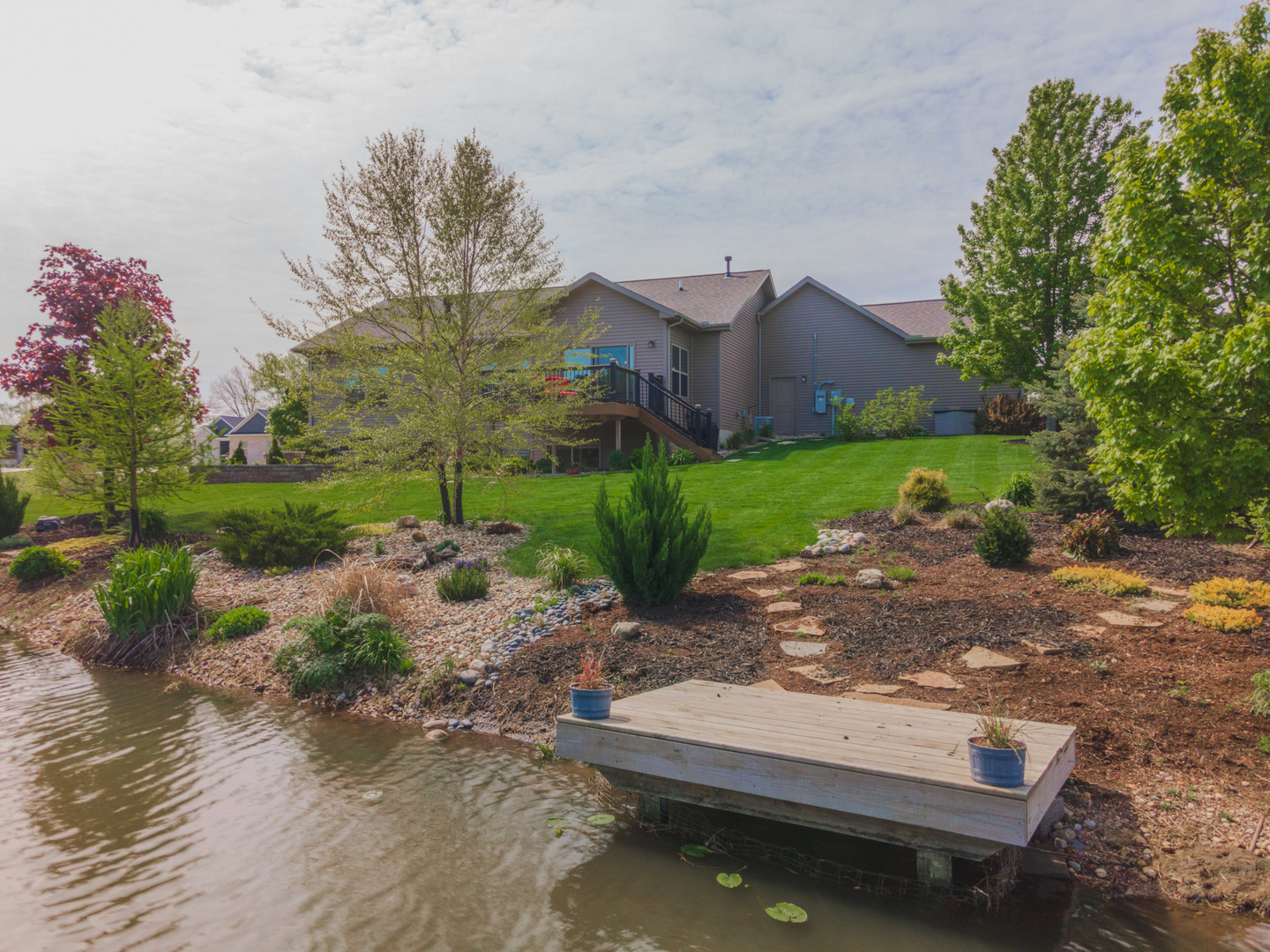 15924 Belfry Drive Bloomington, IL 61705 - Photo 11 of 59 a view of a backyard with plants and a lake view