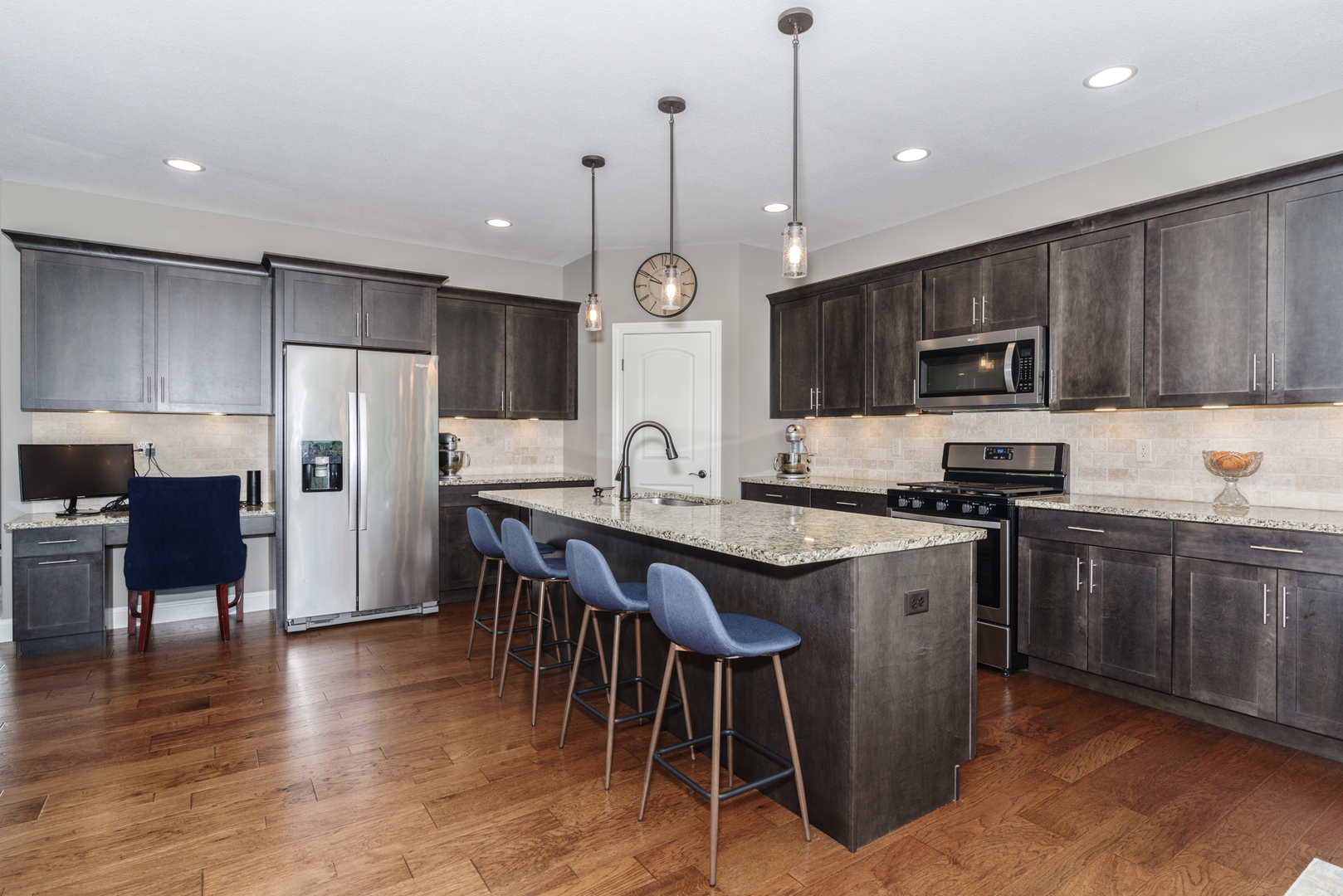 15924 Belfry Drive Bloomington, IL 61705 - Photo 20 of 59 a kitchen with stainless steel appliances granite countertop a refrigerator a stove a sink a dining table and chairs