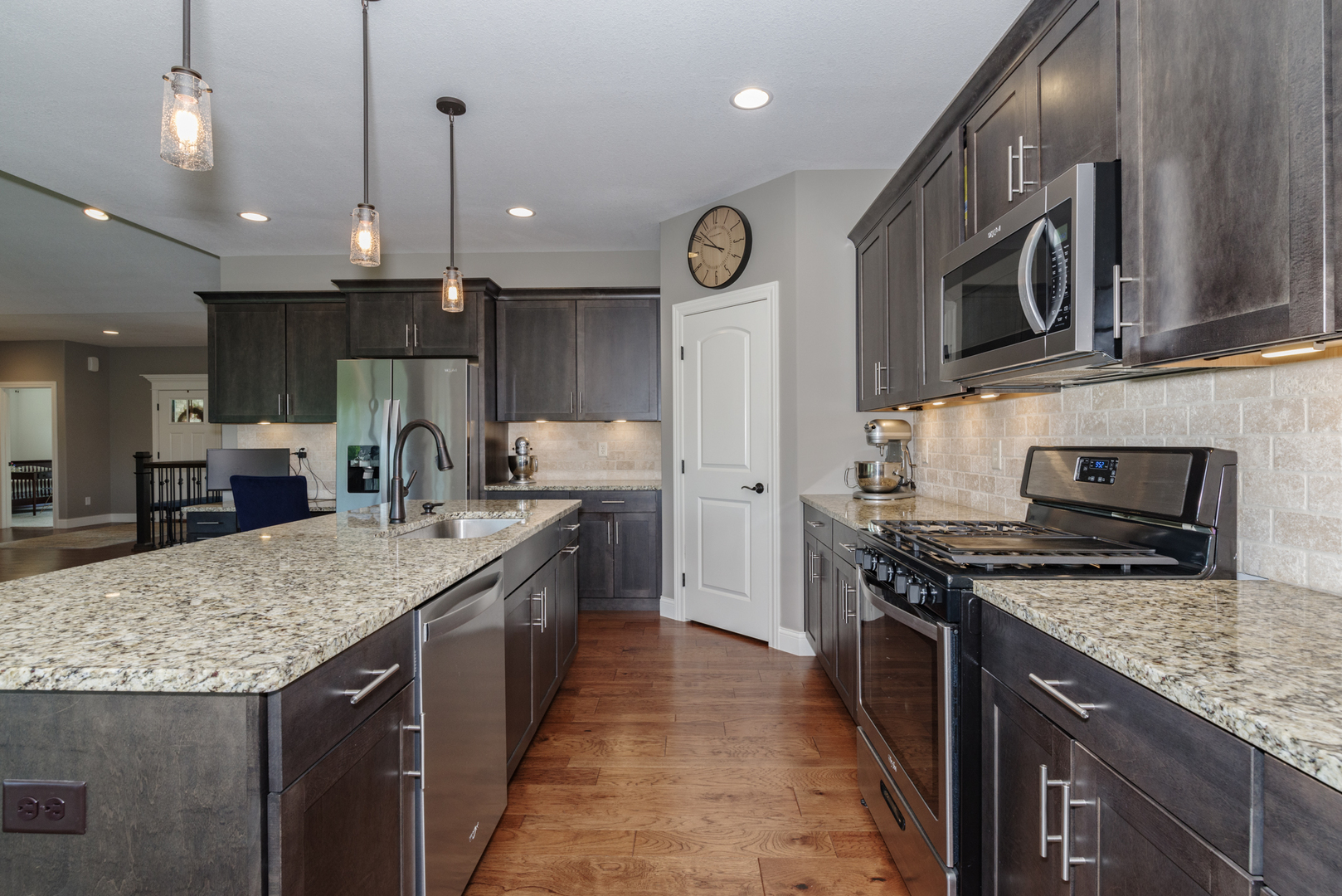 15924 Belfry Drive Bloomington, IL 61705 - Photo 24 of 59 a kitchen with stainless steel appliances granite countertop a stove a sink a microwave oven and a center island