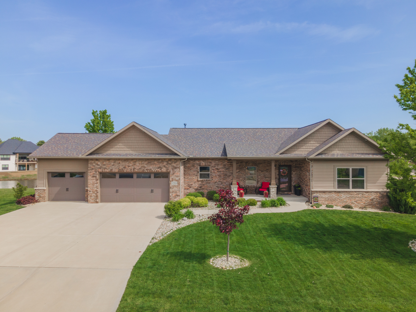 15924 Belfry Drive Bloomington, IL 61705 - Photo 53 of 59 a front view of a house with a yard and trees