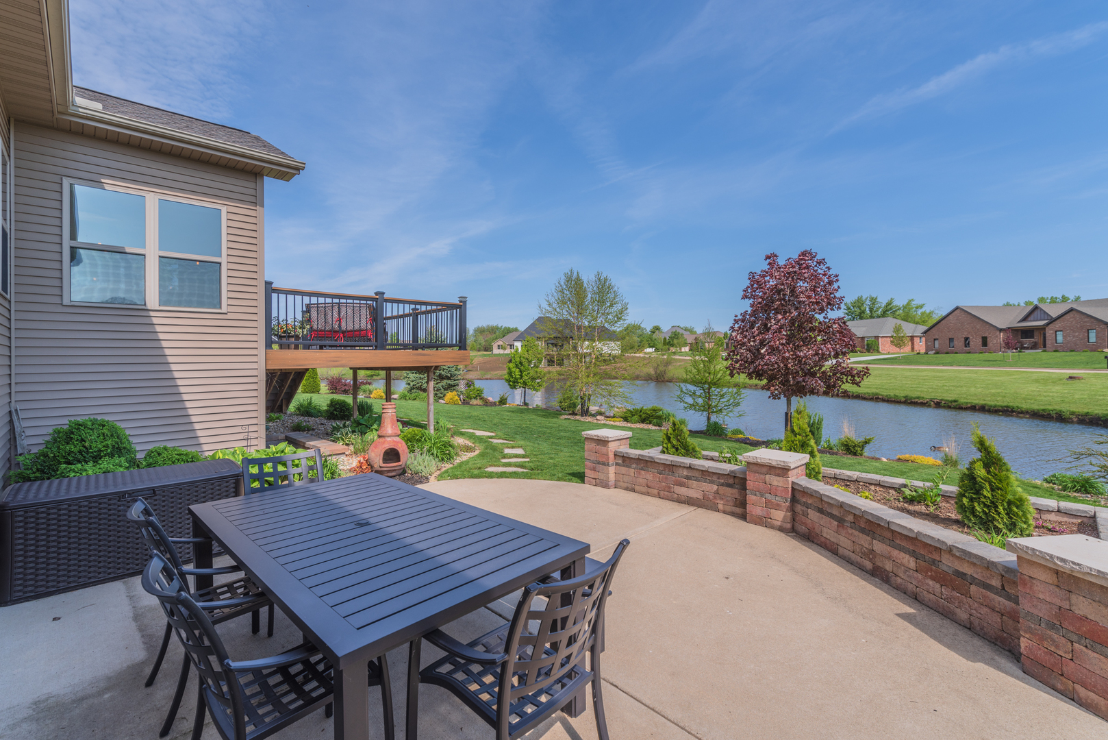 15924 Belfry Drive Bloomington, IL 61705 - Photo 7 of 59 a view of a patio with table and chairs potted plants with wooden floor