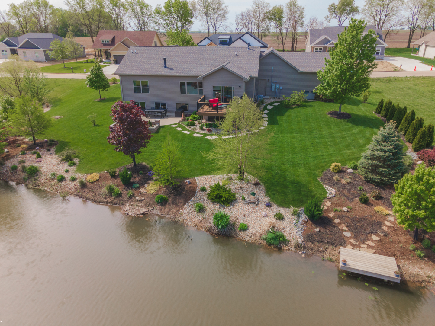 15924 Belfry Drive Bloomington, IL 61705 - Photo 10 of 59 an aerial view of a house with a garden and lake view