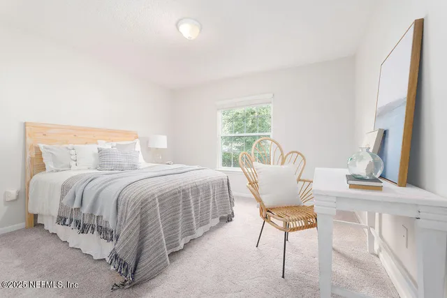 a bedroom with a bed chair and window