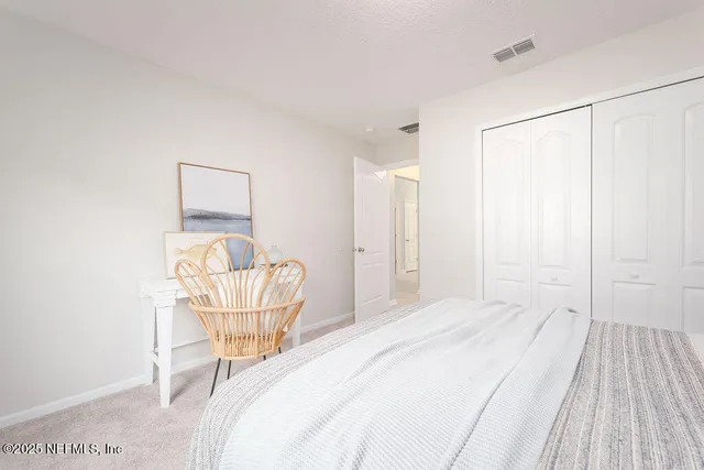 a bedroom with a bed and chair