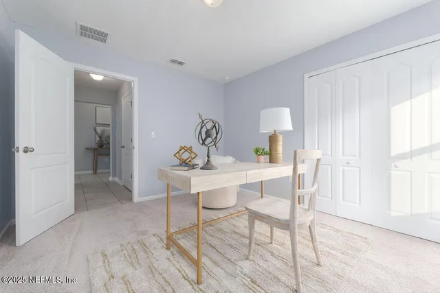 a view of a dining room with furniture and a window