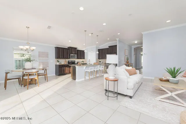 a living room with furniture and kitchen view