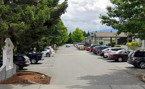 a row of cars parked in front of a house