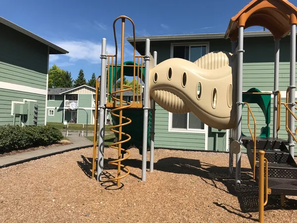 a view of a house with a wooden deck