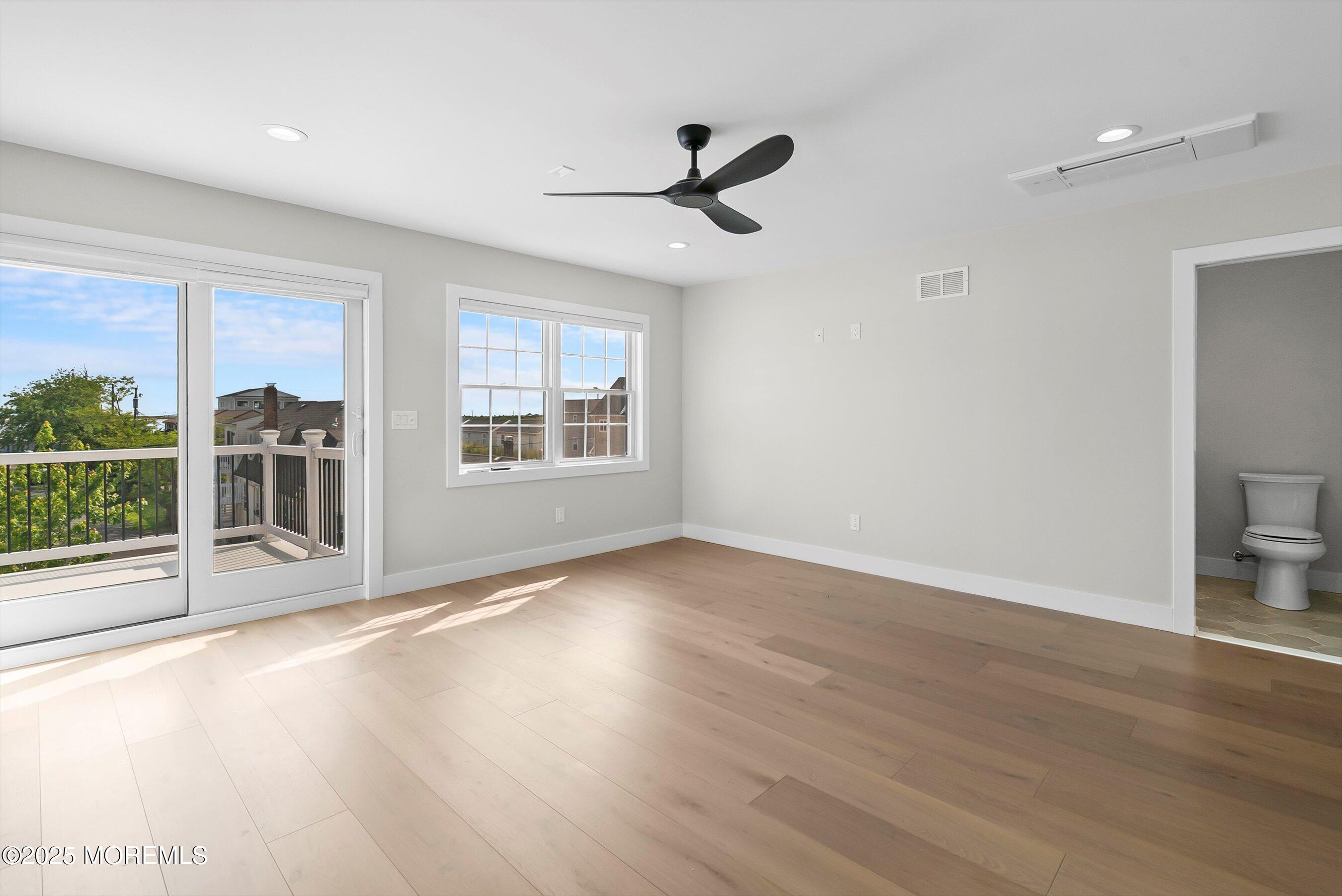 72 4th Street Highlands, NJ 07732 - Photo 14 of 43 a view of an empty room with a window and wooden floor