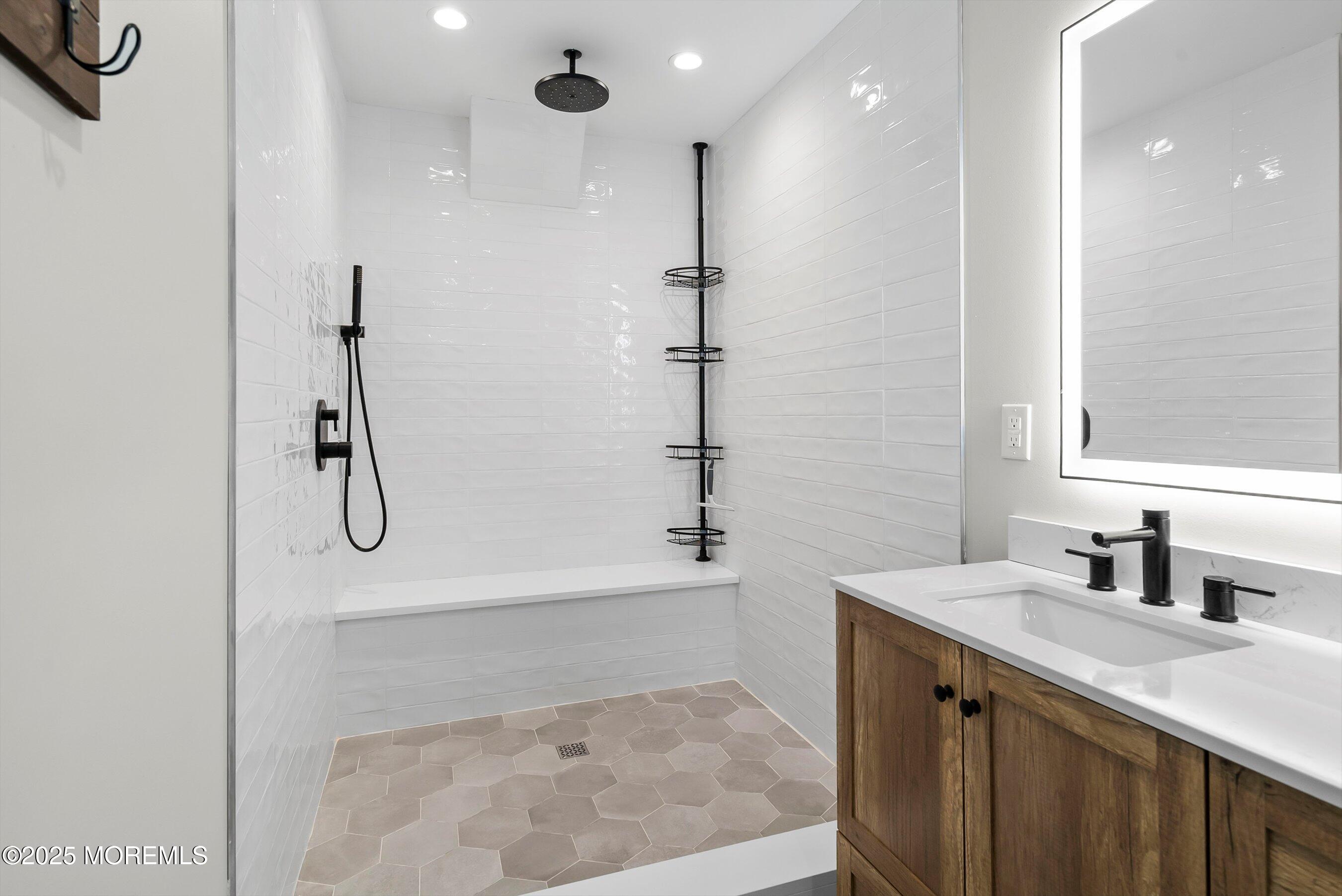 72 4th Street Highlands, NJ 07732 - Photo 17 of 43 a bathroom with a granite countertop shower a sink and a mirror