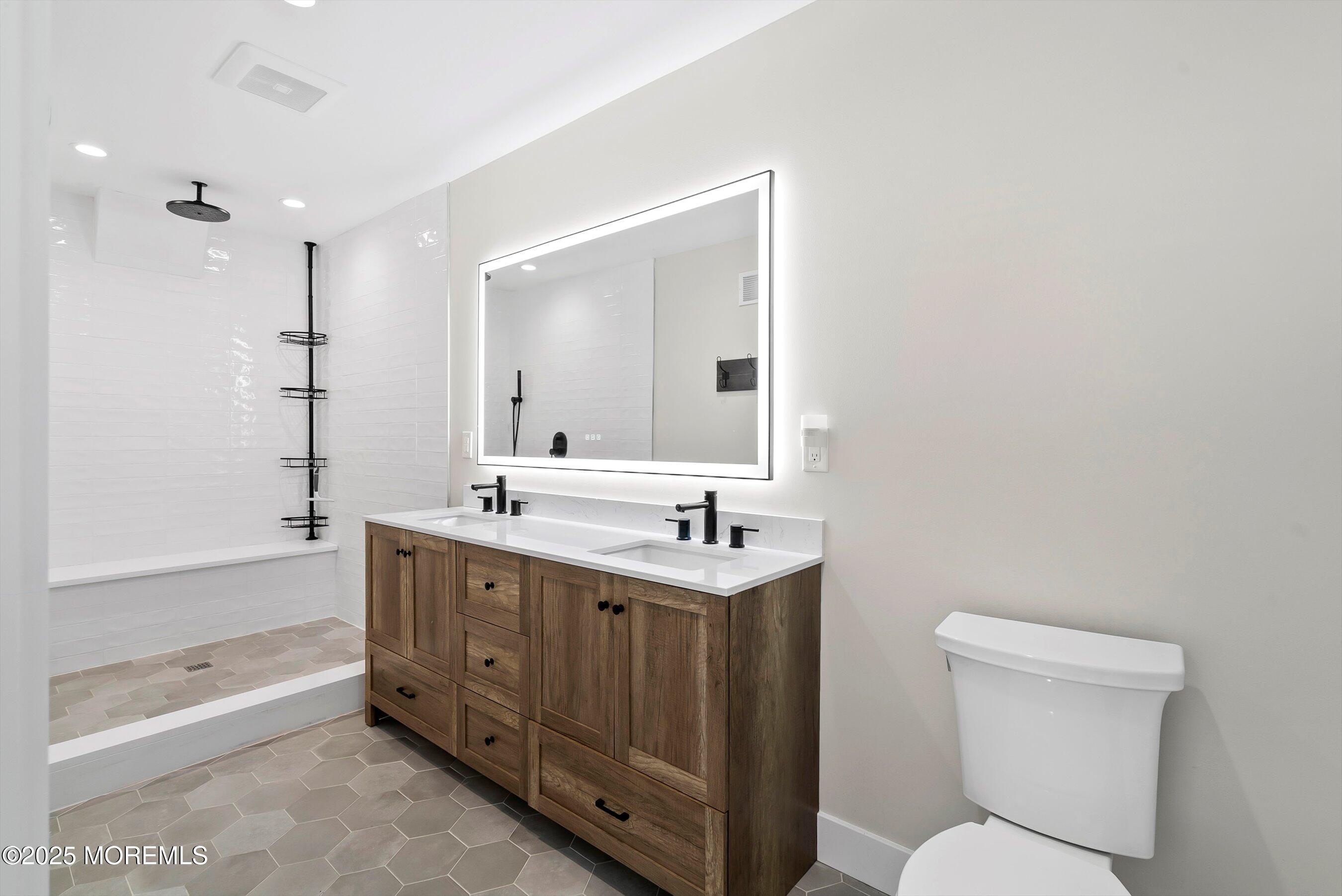 72 4th Street Highlands, NJ 07732 - Photo 18 of 43 a bathroom with a toilet a sink a mirror a bathtub and vanity