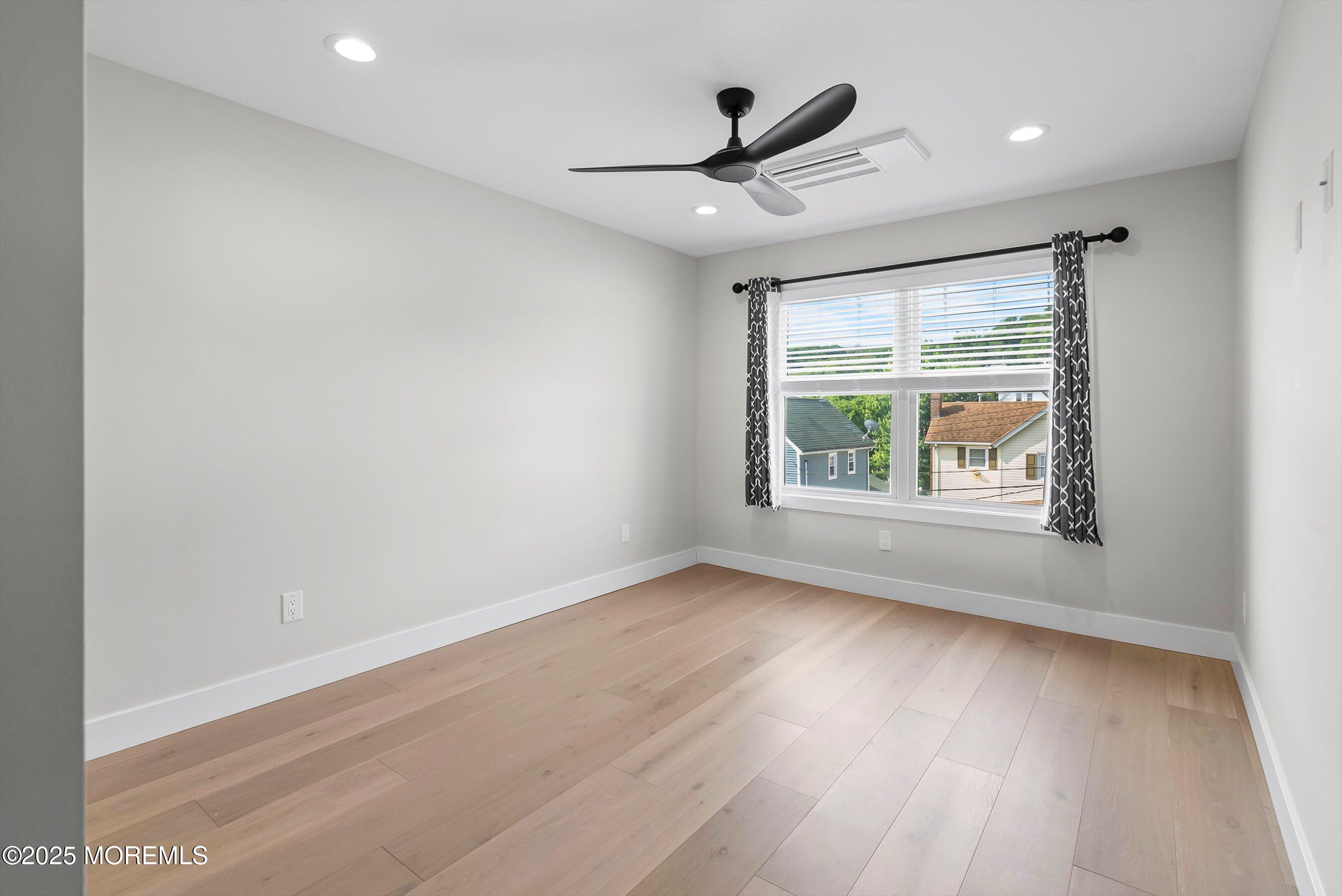 72 4th Street Highlands, NJ 07732 - Photo 20 of 43 a view of empty room with wooden floor and fan