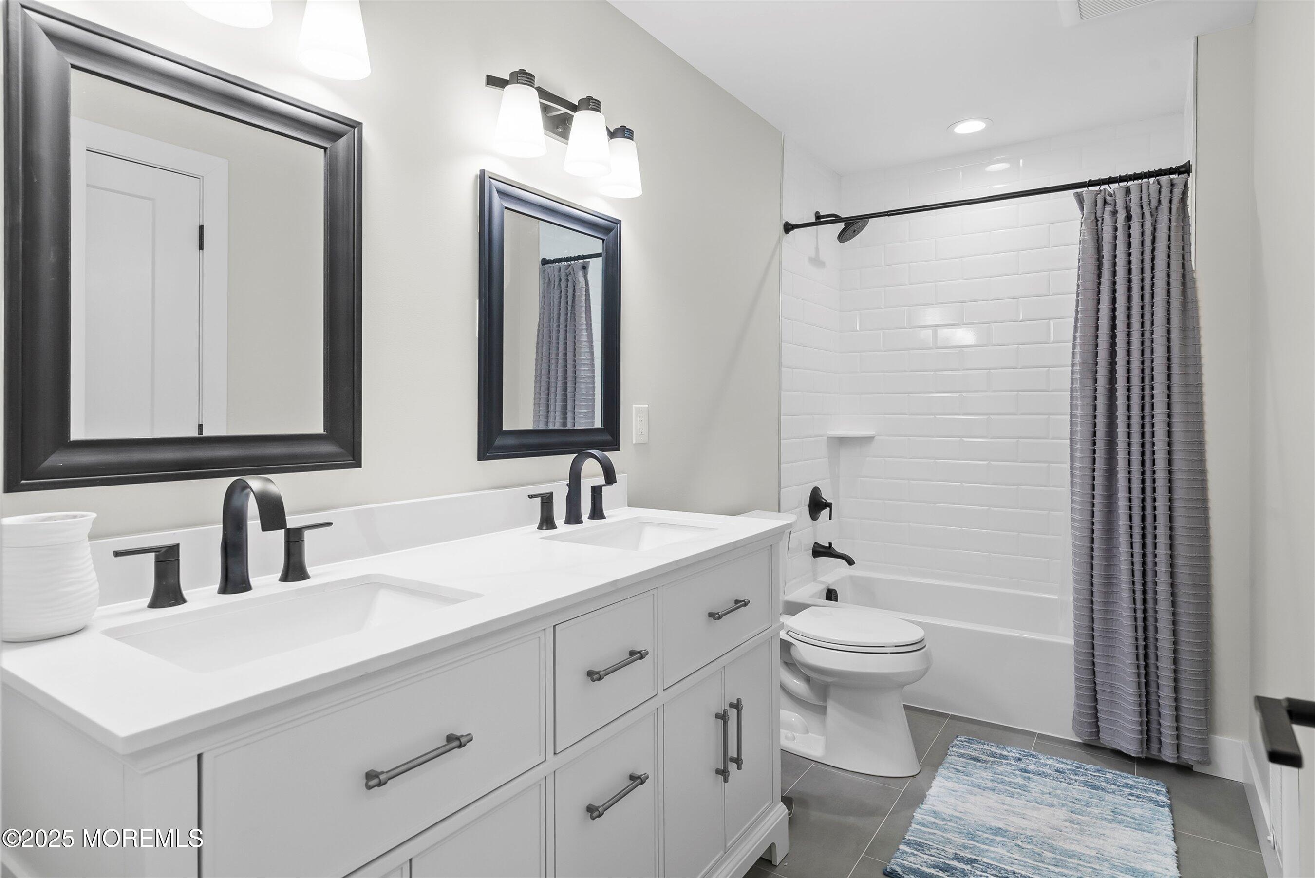 72 4th Street Highlands, NJ 07732 - Photo 23 of 43 a bathroom with a double vanity sink toilet mirror and shower