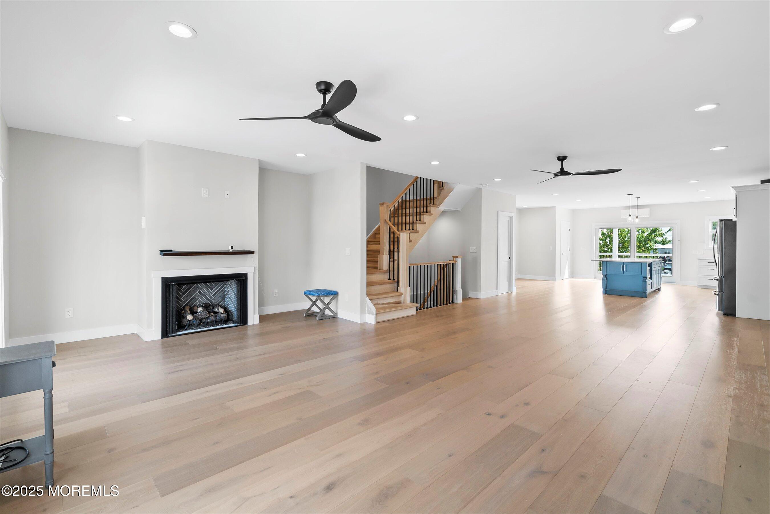72 4th Street Highlands, NJ 07732 - Photo 4 of 43 a view of an empty room with wooden floor fireplace and a window
