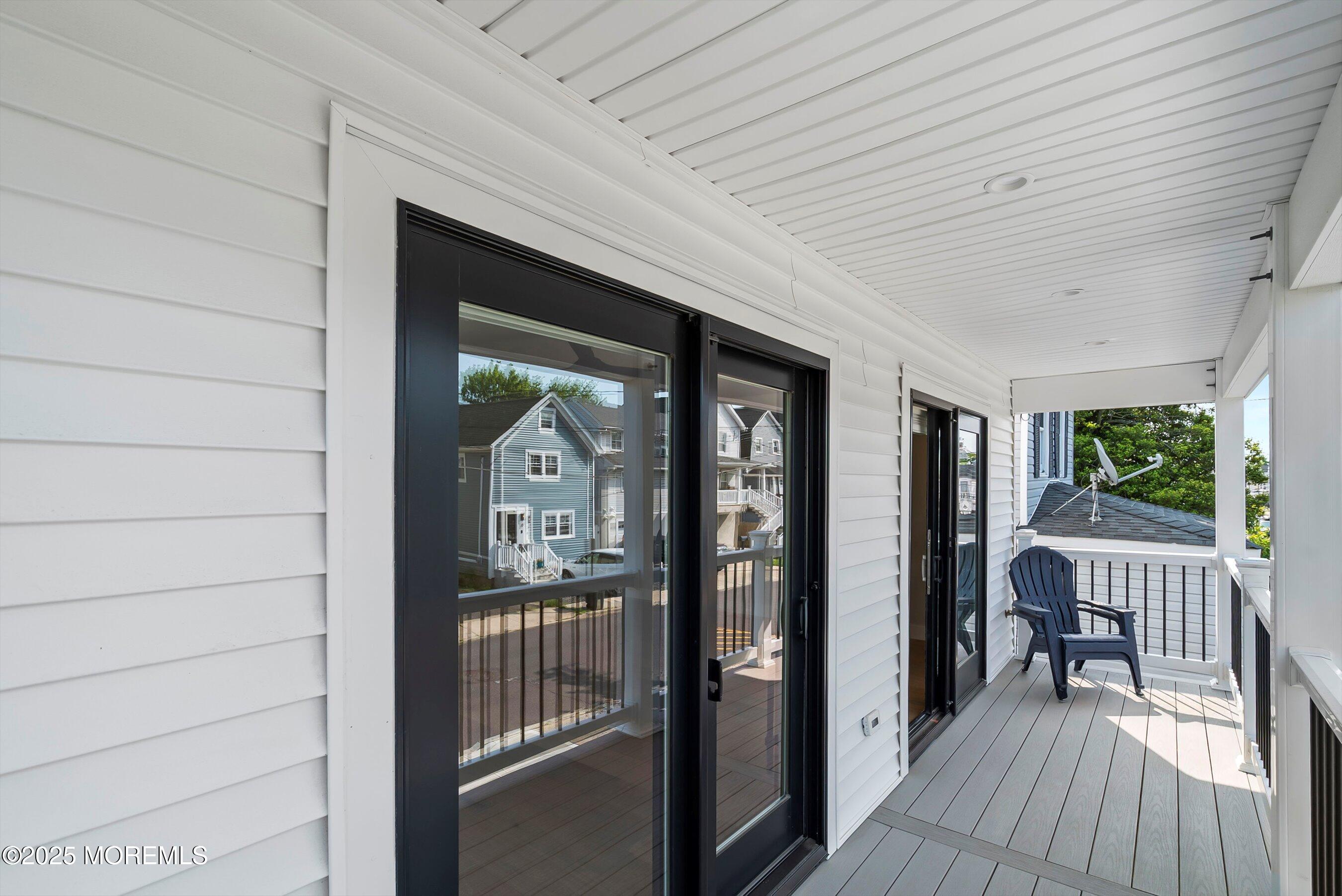 72 4th Street Highlands, NJ 07732 - Photo 6 of 43 a view of a balcony and dining area with furniture