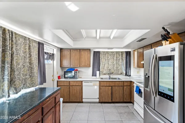 a kitchen with stainless steel appliances a refrigerator sink and cabinets