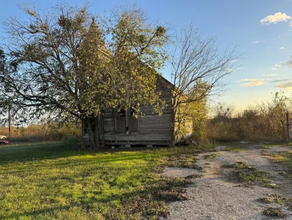 a view of a yard with wooden fence