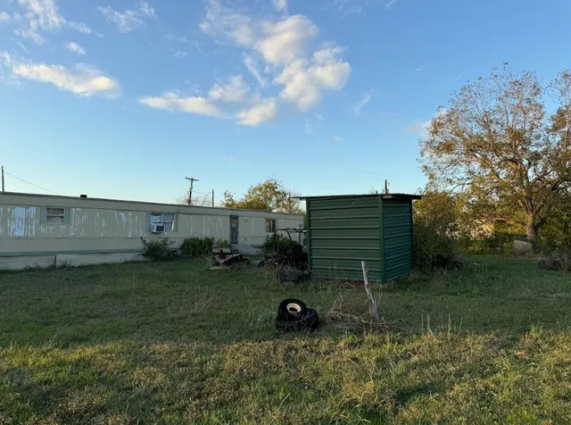 a view of a park with large trees
