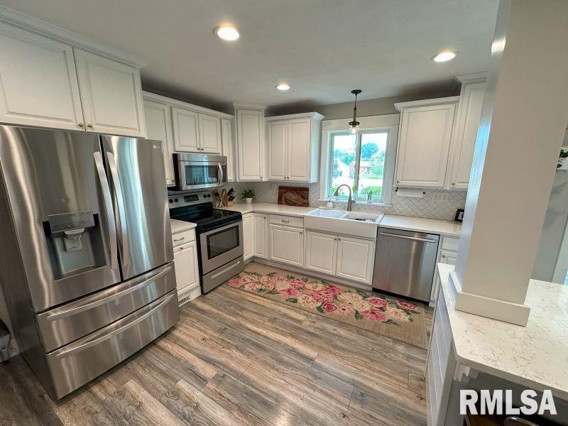 1144 Brookview Drive Dewitt, IA 52742 - Photo 11 of 28 a kitchen with refrigerator cabinets and wooden floor