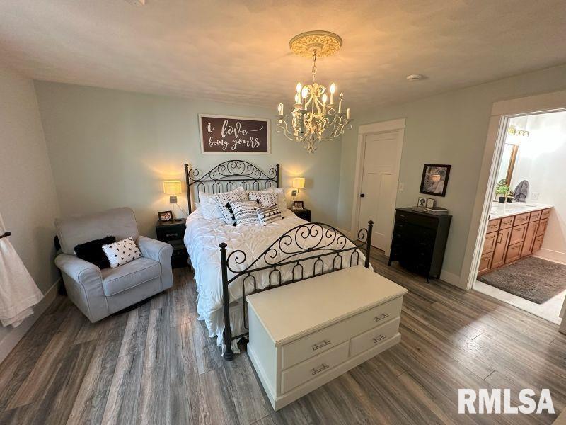 1144 Brookview Drive Dewitt, IA 52742 - Photo 16 of 28 a spacious bedroom with a bed and wooden floor