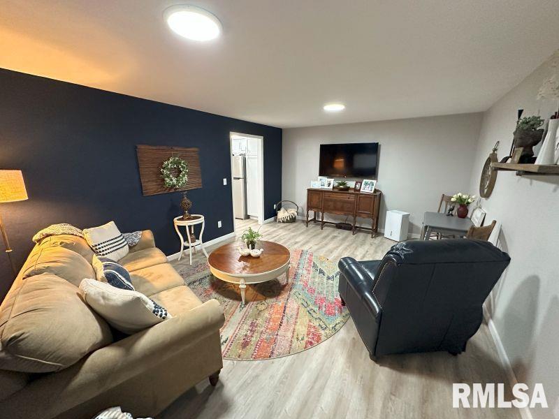 1144 Brookview Drive Dewitt, IA 52742 - Photo 22 of 28 a living room with furniture and a flat screen tv