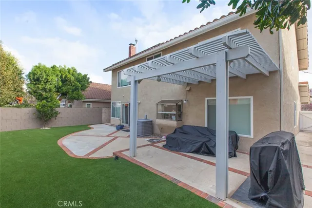 a view of backyard with swimming pool and furniture