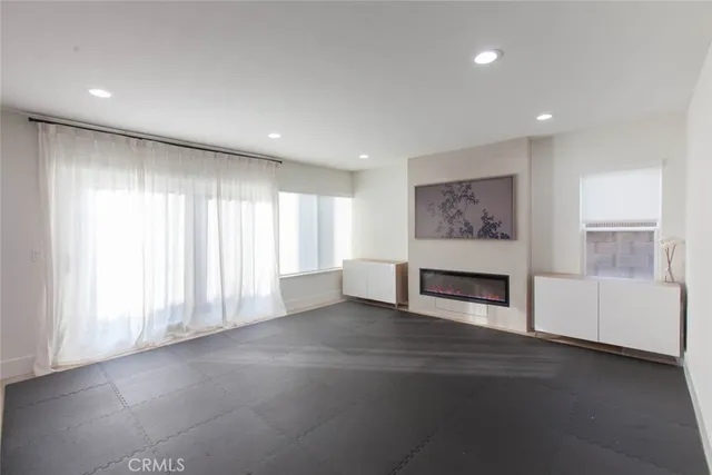 a view of an empty room with a fireplace and a window