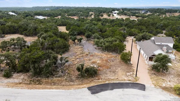 an aerial view of a house with a yard