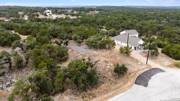 an aerial view of a house with a yard