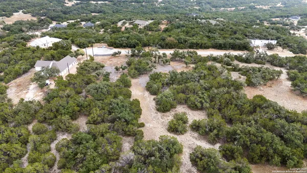 an aerial view of house with yard and green space