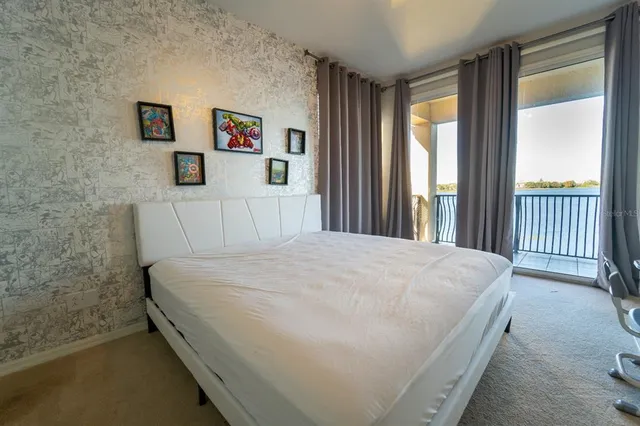 a large bed sitting in a bedroom next to a window