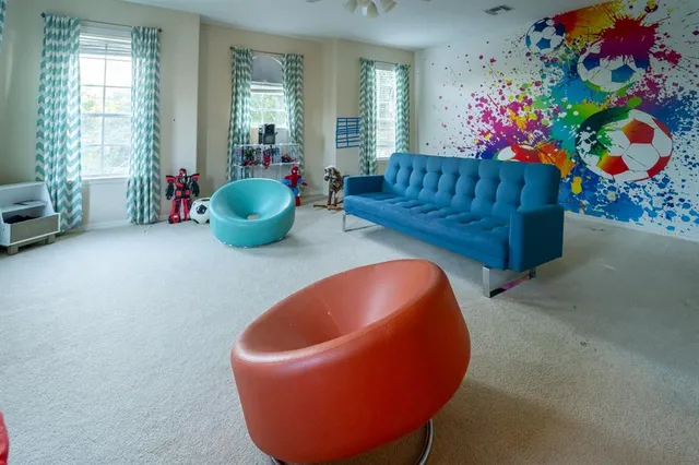 a living room with furniture and flowers