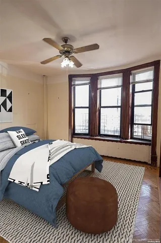 a spacious bedroom with a bed and a large window