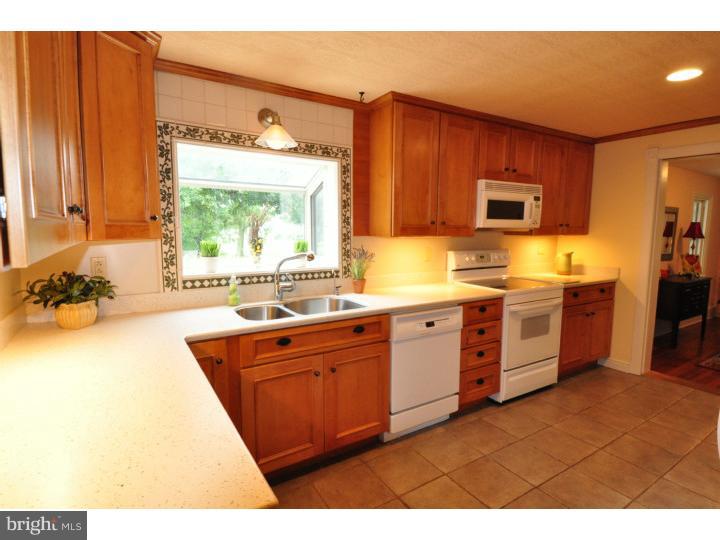 155 Sharp Road Avondale, PA 19311 - Photo 12 of 25 a large kitchen with stainless steel appliances granite countertop a stove a sink and a microwave