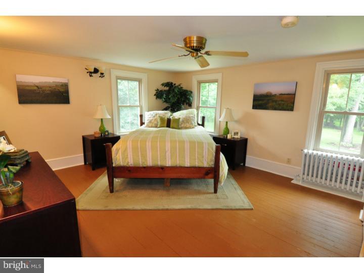 155 Sharp Road Avondale, PA 19311 - Photo 25 of 25 a bedroom with a bed and wooden floor