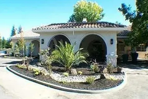 a view of a house with potted plants