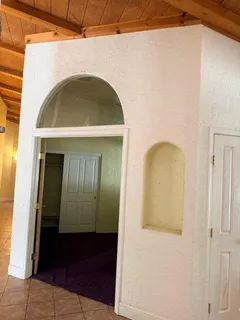 a room with stainless steel appliances kitchen island granite countertop furniture and a refrigerator