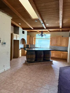 a view of an empty room with a fireplace and a window