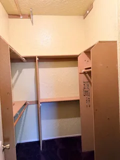 a bathroom with a granite countertop toilet and a sink