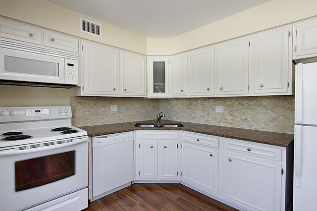 715 Ridge Road, Unit 4E Wilmette, IL 60091 - Photo 3 of 7 a kitchen with granite countertop white cabinets and stainless steel appliances