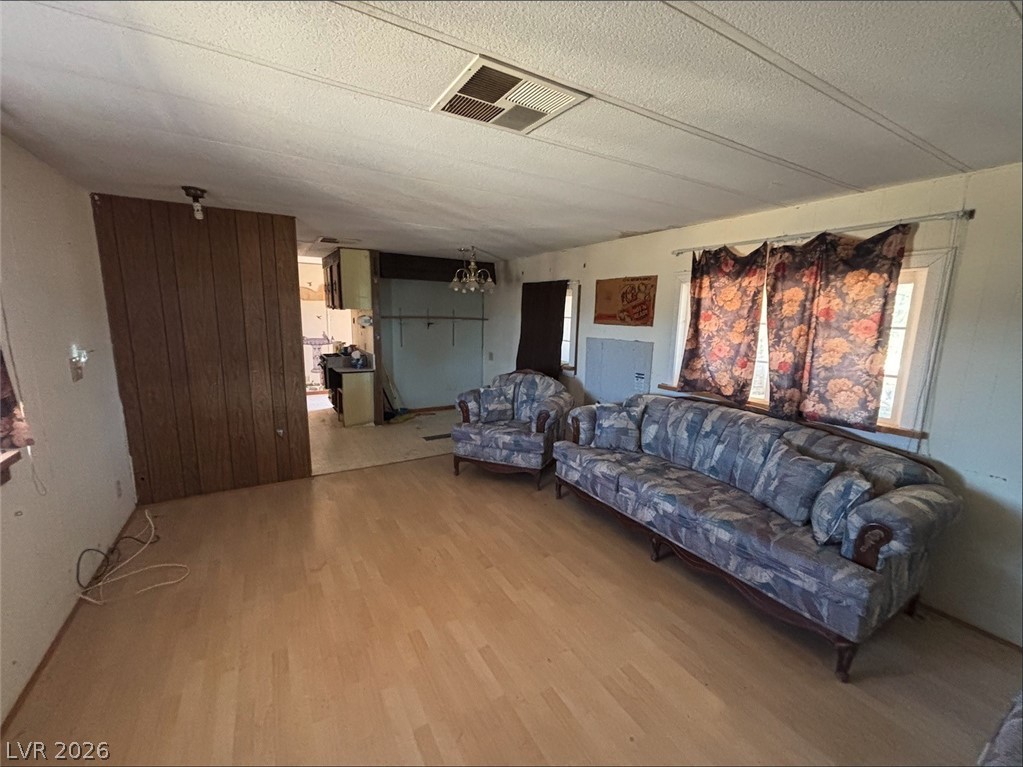 1301 East Manse Road Pahrump, NV 89048 - Photo 11 of 14 Blonde wood flooring creates a sense of openness in this well-lit living area.