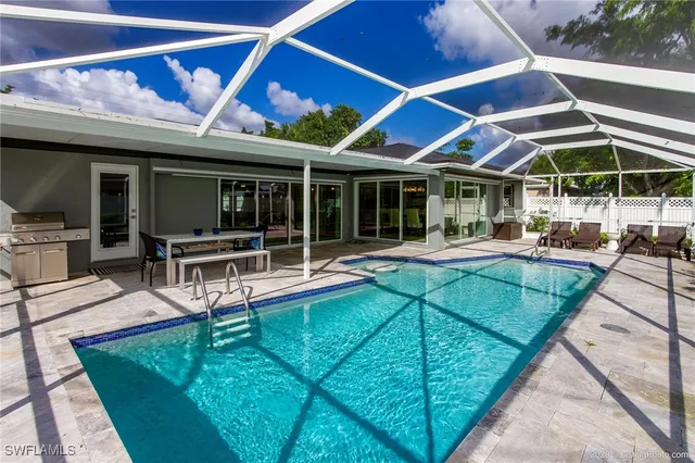 a view of a patio with table and chairs under an umbrella