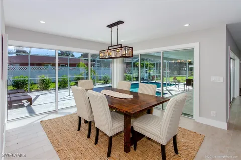 a dining room with furniture wooden floor and a garden
