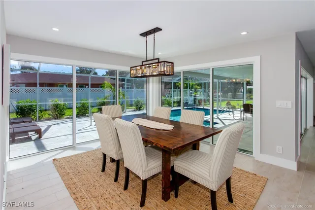 a dining room with furniture wooden floor and a garden