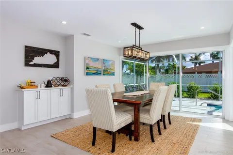 a dining room with furniture a garden and chandelier