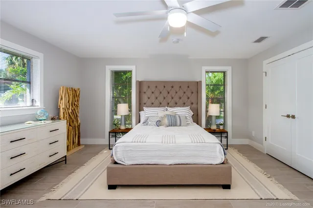 a bedroom with a large bed and a window