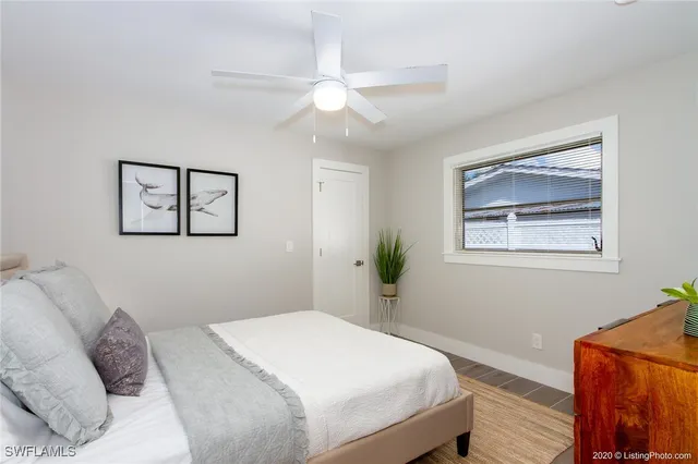 a bedroom with a bed and a painting on the wall